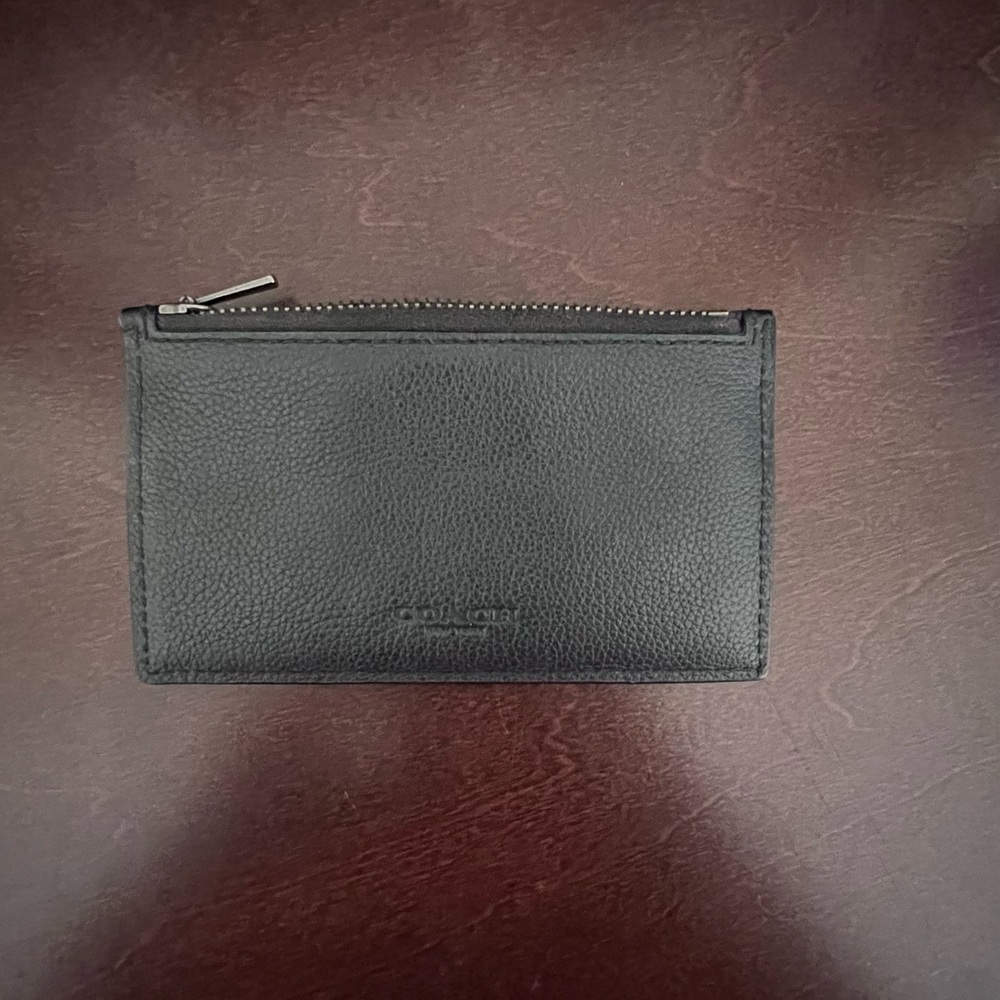Coach card holder with zippered pocket and lots of slots for cards. Never used.